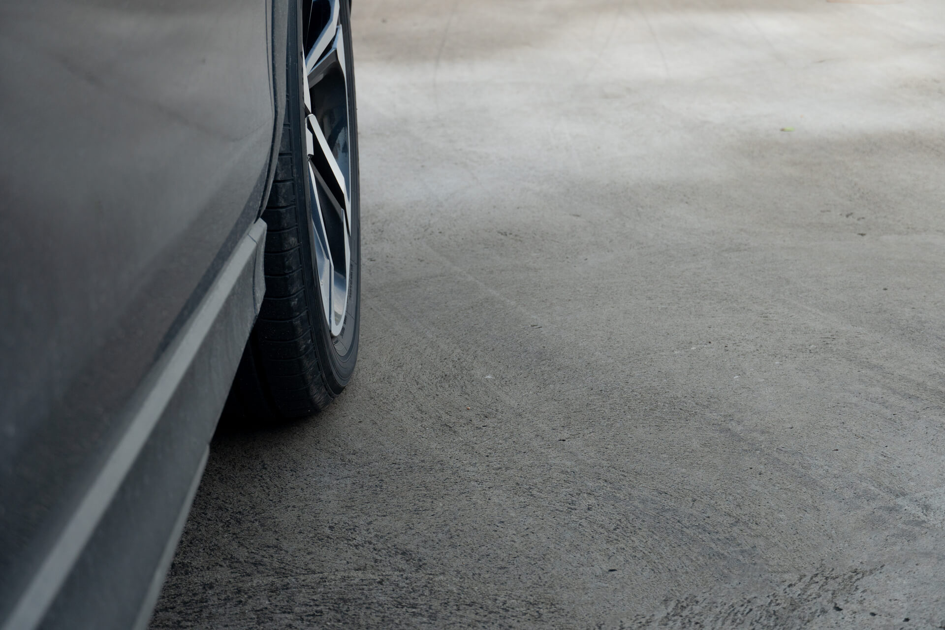 medium-vecteezy_car-parked-on-a-concrete-driveway-car-is-dark-gray-in-color_51567936_medium (1)